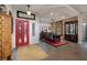 Inviting foyer with a red front door, tile flooring, and a formal dining area at 1657 Hartley Ave, Henderson, NV 89052