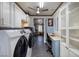 Spacious laundry room with ample cabinetry, countertop space, and stainless steel appliances at 1657 Hartley Ave, Henderson, NV 89052