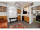 Cozy living room features a custom bar, exposed brick wall, and plantation shutters for light control at 1657 Hartley Ave, Henderson, NV 89052