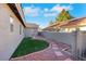 Home's backyard featuring mature desert landscaping, a private entry door, and more at 1808 Scenic Sunrise Dr, Las Vegas, NV 89117