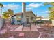 Backyard view of the home featuring patio seating and desert landscaping at 1808 Scenic Sunrise Dr, Las Vegas, NV 89117