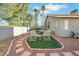 Inviting backyard with lounge chairs, patio set, and mature desert landscaping at 1808 Scenic Sunrise Dr, Las Vegas, NV 89117