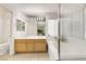 Well-lit bathroom has double sinks, wooden cabinets and a glass shower door at 1808 Scenic Sunrise Dr, Las Vegas, NV 89117
