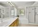 This bathroom features a soaking tub, glass shower, dual sinks, and wallpaper at 1808 Scenic Sunrise Dr, Las Vegas, NV 89117