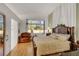 Bedroom featuring a wooden bed frame, a leather chair and an exit door to the backyard at 1808 Scenic Sunrise Dr, Las Vegas, NV 89117