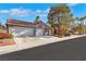 Charming single-story home with a two-car garage and well-manicured landscaping at 1808 Scenic Sunrise Dr, Las Vegas, NV 89117