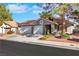 Beautiful single-story home featuring a two-car garage, tiled roof, and neatly landscaped front yard at 1808 Scenic Sunrise Dr, Las Vegas, NV 89117