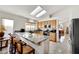 Bright kitchen with granite countertops, stainless steel appliances, and cozy breakfast bar seating at 1808 Scenic Sunrise Dr, Las Vegas, NV 89117