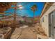 Backyard area with desert landscaping, palm trees, and ample space for relaxation or entertainment at 186 Shaded Peak St, Henderson, NV 89012