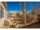 Spacious backyard with potential for customization, featuring gravel, plants, and block wall fencing at 186 Shaded Peak St, Henderson, NV 89012