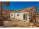 Exterior rear view of home showcasing a spacious, low-maintenance backyard with desert landscaping at 186 Shaded Peak St, Henderson, NV 89012