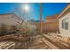 Landscaped backyard featuring desert plants, a bench, and outdoor seating under the bright sun at 186 Shaded Peak St, Henderson, NV 89012