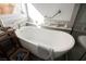 Sunlit bathroom featuring an elegant, freestanding soaking tub and modern fixtures at 186 Shaded Peak St, Henderson, NV 89012