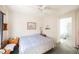 Bright bedroom with a ceiling fan, a picture frame, and a light blue comforter at 186 Shaded Peak St, Henderson, NV 89012