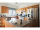Efficient kitchen with stainless steel refrigerator, ample cabinets, and functional center island at 186 Shaded Peak St, Henderson, NV 89012