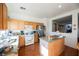 Well lit kitchen features stainless steel appliances, wood cabinets and view to Gathering room at 186 Shaded Peak St, Henderson, NV 89012