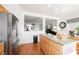 Bright kitchen with stainless steel refrigerator, island and view into the Gathering room at 186 Shaded Peak St, Henderson, NV 89012