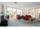 Spacious living room with neutral carpet, fireplace, and open layout to the dining area at 186 Shaded Peak St, Henderson, NV 89012