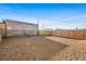 The expansive gravel backyard featuring chain link and wood fencing provides ample space at 19 Montana Way, Henderson, NV 89015