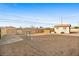 Large gravel backyard featuring privacy and chain link fencing with a small storage shed at 19 Montana Way, Henderson, NV 89015