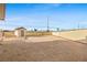 Gravel backyard with block wall and wood fence featuring shed for extra storage at 19 Montana Way, Henderson, NV 89015