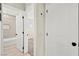 Bathroom with tub and tiled wall, with view to hallway and bedroom at 19 Montana Way, Henderson, NV 89015