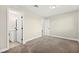Bright bedroom with neutral walls and carpet, with an ensuite bathroom at 19 Montana Way, Henderson, NV 89015
