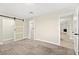 Cozy bedroom with soft carpet flooring, a sliding barn door closet, and neutral paint at 19 Montana Way, Henderson, NV 89015