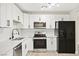 Modern kitchen with stainless steel appliances, marble countertops, and sleek white cabinetry at 19 Montana Way, Henderson, NV 89015