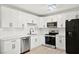 Beautiful kitchen with white cabinets, quartz countertops, stainless appliances, and modern fixtures at 19 Montana Way, Henderson, NV 89015