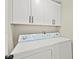 Bright laundry area with white cabinets, modern appliances, and efficient layout at 19 Montana Way, Henderson, NV 89015