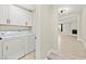 Well-lit laundry room with white cabinets and modern washer and dryer at 19 Montana Way, Henderson, NV 89015