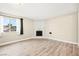Bright living room with wood-look floors, decorative fireplace, and a large window at 19 Montana Way, Henderson, NV 89015