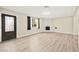 Inviting living room featuring wood-look floors, a decorative fireplace, and ample natural light at 19 Montana Way, Henderson, NV 89015