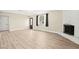 Bright living room featuring light wood floors, stylish fireplace, and natural light from the window at 19 Montana Way, Henderson, NV 89015