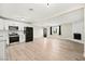 Open concept living area with modern kitchen, fireplace, and natural light at 19 Montana Way, Henderson, NV 89015