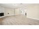 Open-concept living space featuring wood-look floors, modern lighting, and a fireplace at 19 Montana Way, Henderson, NV 89015