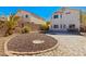 Low maintenance backyard features decorative rock, defined brick edging, and a patio seating area at 2276 Laramine River Dr, Henderson, NV 89052
