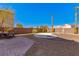 Landscaped backyard with stone, brick, and desert landscaping at 2276 Laramine River Dr, Henderson, NV 89052
