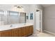 Bathroom with double sinks, large mirror, and adjacent shower/tub at 2276 Laramine River Dr, Henderson, NV 89052