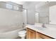 Bathroom with a tiled shower-tub combo, single sink vanity, and white toilet at 2276 Laramine River Dr, Henderson, NV 89052