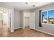 Upstairs bedroom with hardwood floors, a large window, and an adjacent walk-in closet at 2276 Laramine River Dr, Henderson, NV 89052
