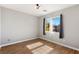 Bright bedroom features wood-look flooring, neutral walls, and natural light from the windows at 2276 Laramine River Dr, Henderson, NV 89052
