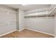 Walk-in closet featuring built-in shelving and laminate wood floors at 2276 Laramine River Dr, Henderson, NV 89052