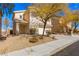 Charming two-story house with a two-car garage, desert landscaping, and a covered porch at 2276 Laramine River Dr, Henderson, NV 89052
