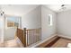 Upstairs hallway with hardwood floors and natural light at 2276 Laramine River Dr, Henderson, NV 89052