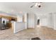 Open-concept living room with tile floors that flow into the adjacent kitchen with stainless appliances at 2276 Laramine River Dr, Henderson, NV 89052