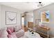 Cozy living room featuring a comfortable pink sofa, a decorative table, and bright natural light at 2276 Laramine River Dr, Henderson, NV 89052