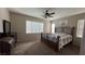 Bedroom features a ceiling fan, carpeted floors, and plenty of natural light from two windows at 257 Homeward Way, Henderson, NV 89011