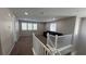 Carpeted upstairs living room with a sofa and multiple windows for natural light at 257 Homeward Way, Henderson, NV 89011